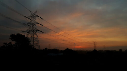 telephone lines through brilliantly colored sunset