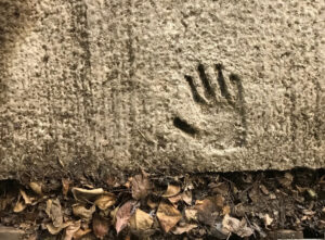 childs hand print in concrete